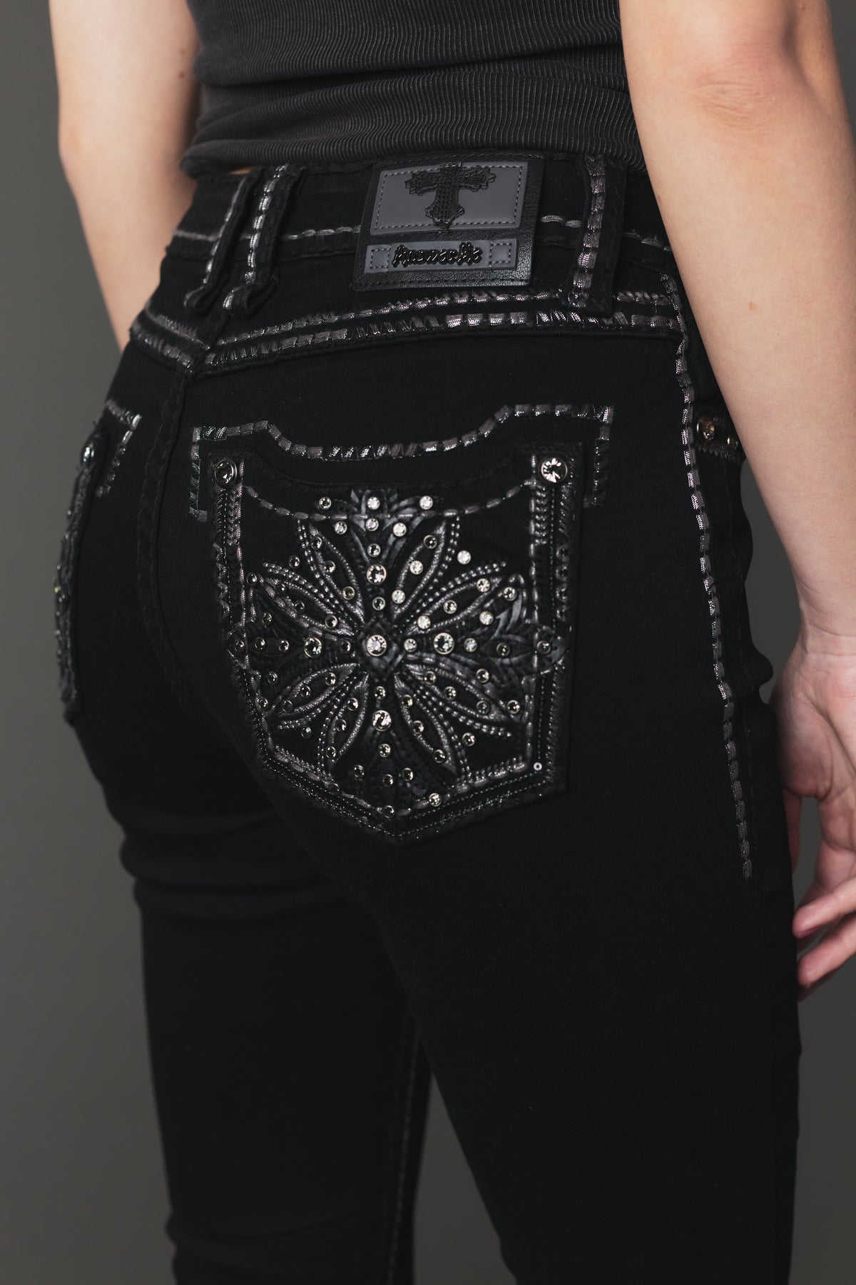 Back pocket star-and-floral embroidery detail on Answer Me A1146 black jeans