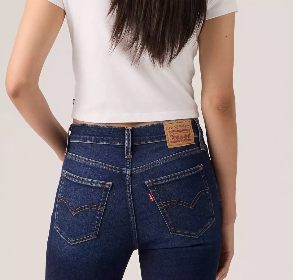 Levi's 720 high rise super skinny women's jeans shown in dark denim, close-up of fit and stitching on the front.