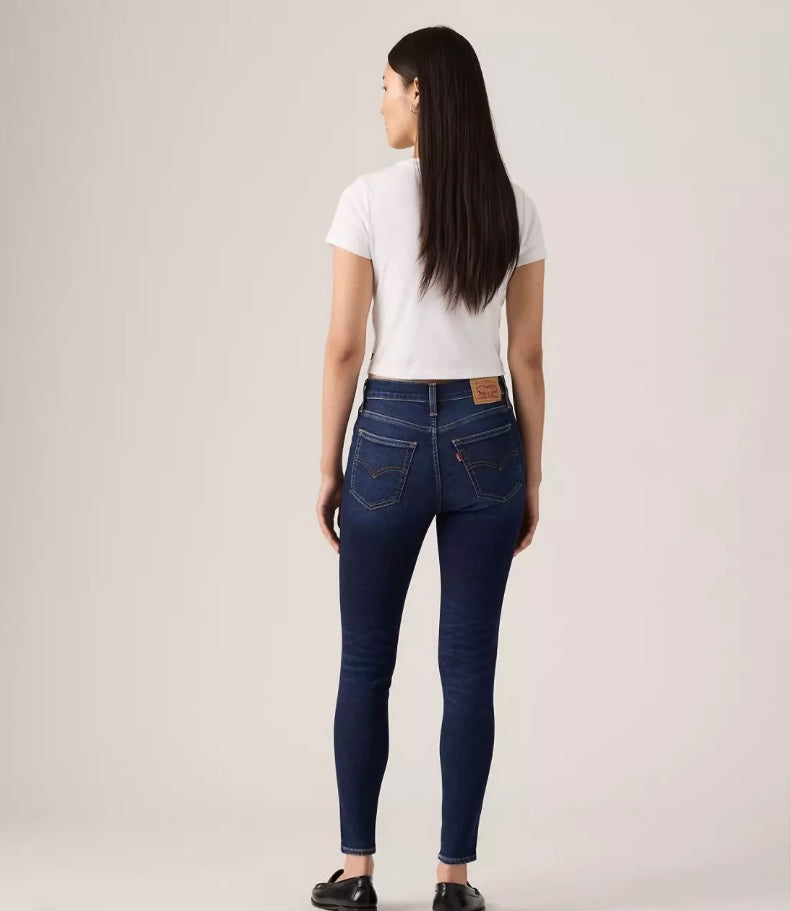 Levi's 720 high rise super skinny women's jeans in dark denim, showcasing a close-up of the fitted style and back pockets.