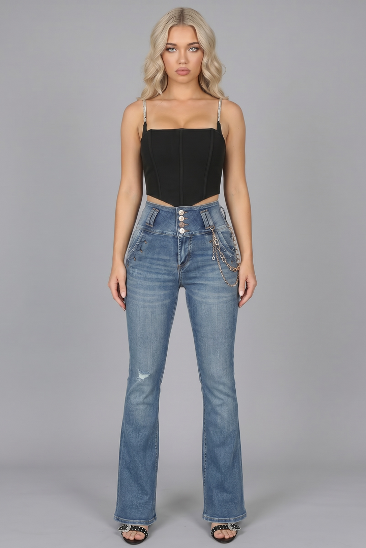 Woman wearing a black top and blue jeans on a gray background