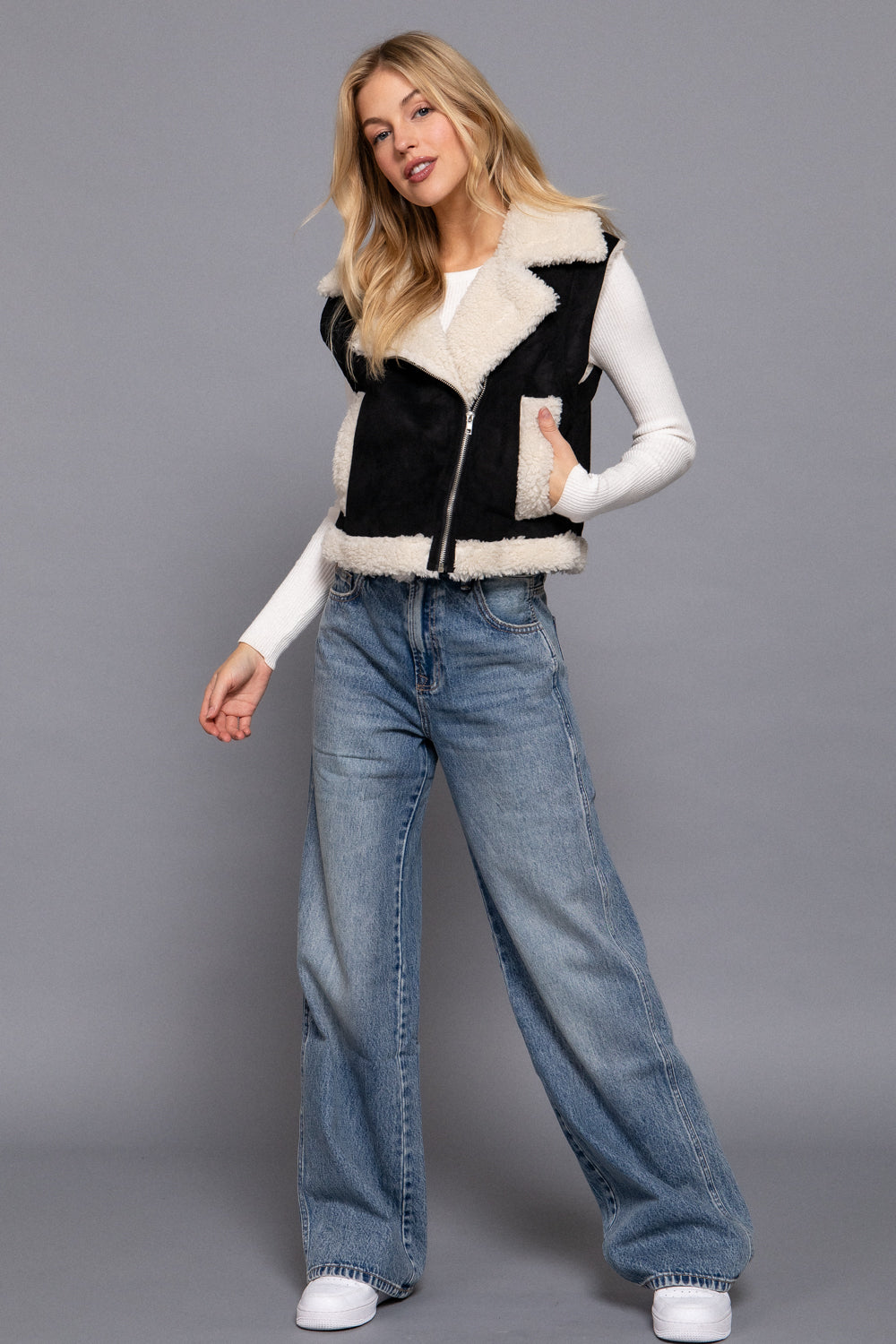 Black faux suede sherpa-lined zip-up vest by Active USA, featuring a cozy sherpa interior and front zipper closure.
