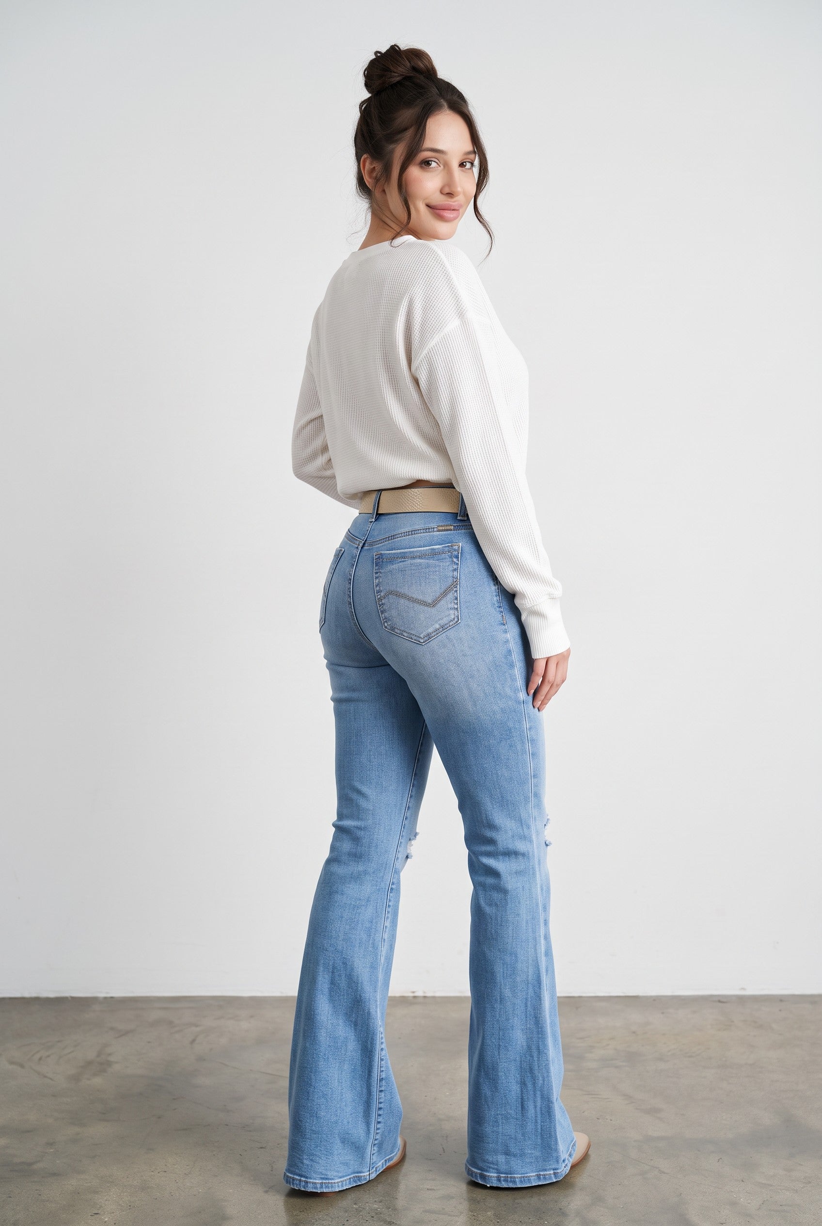 High-rise Western flare jeans in medium blue – back three-quarter view