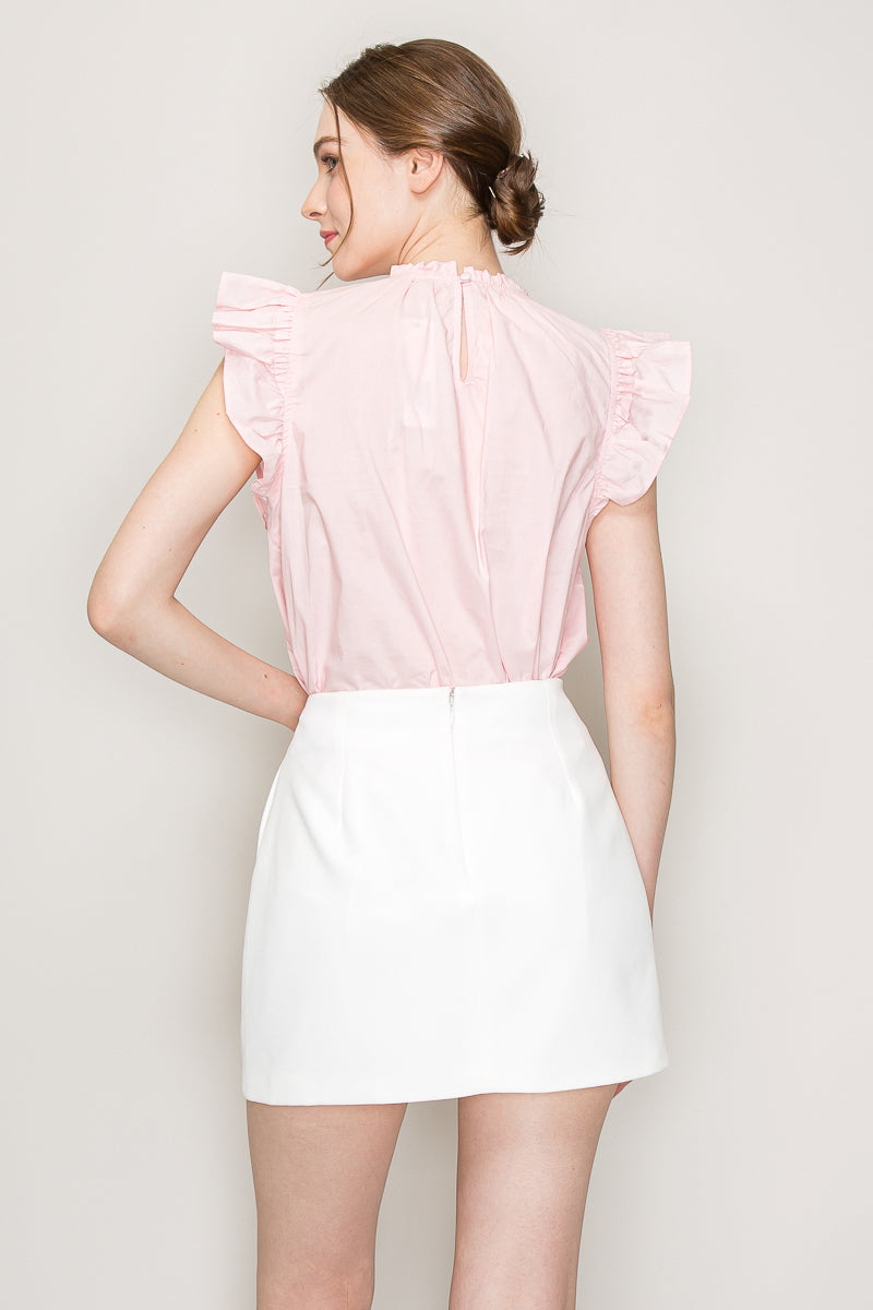 INA cut-out top with flutter sleeves, stylish sleeveless blouse featuring a modern neckline and flowy fabric.