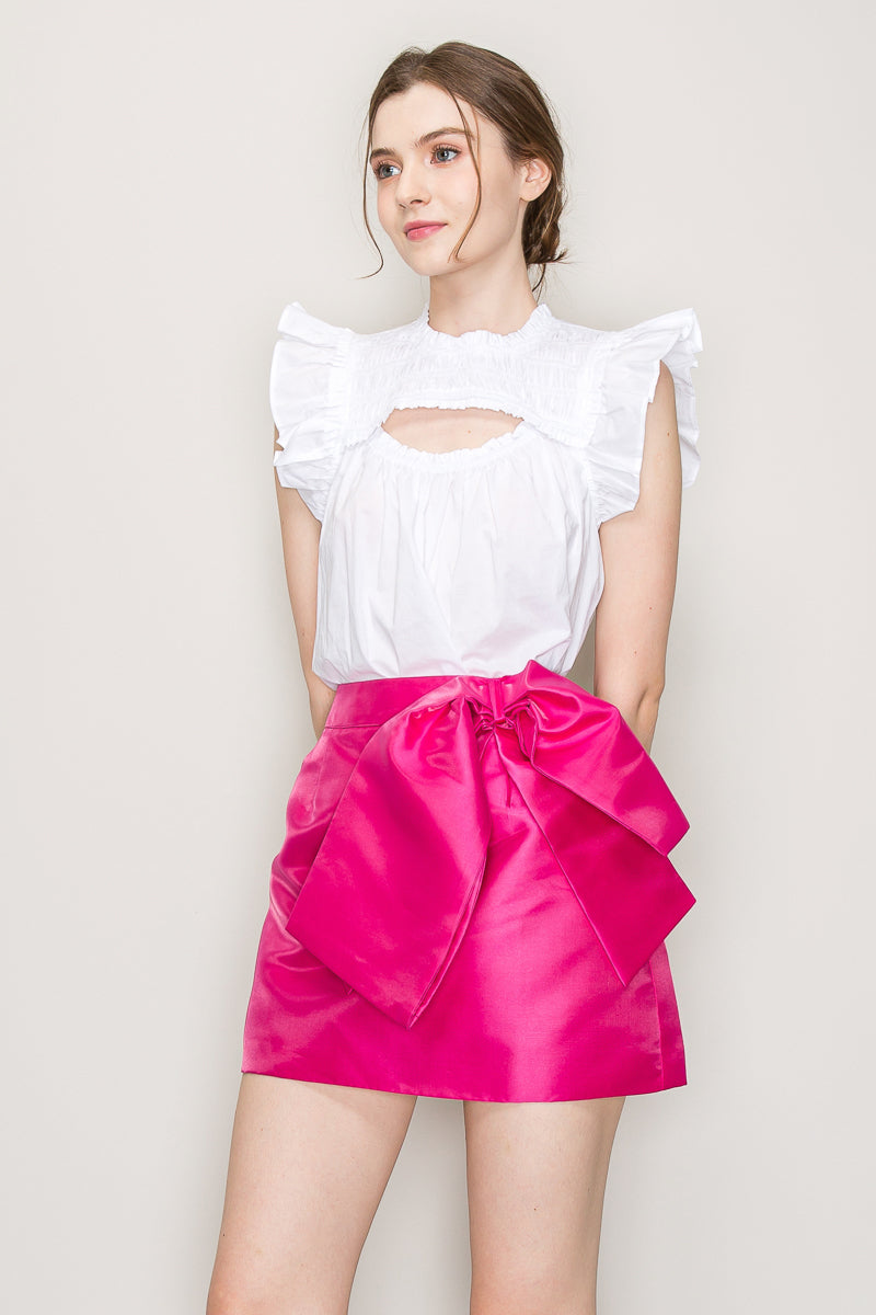 INA cut out top with flutter sleeves, stylish sleeveless blouse featuring a modern cut-out design and flowy flutter details.