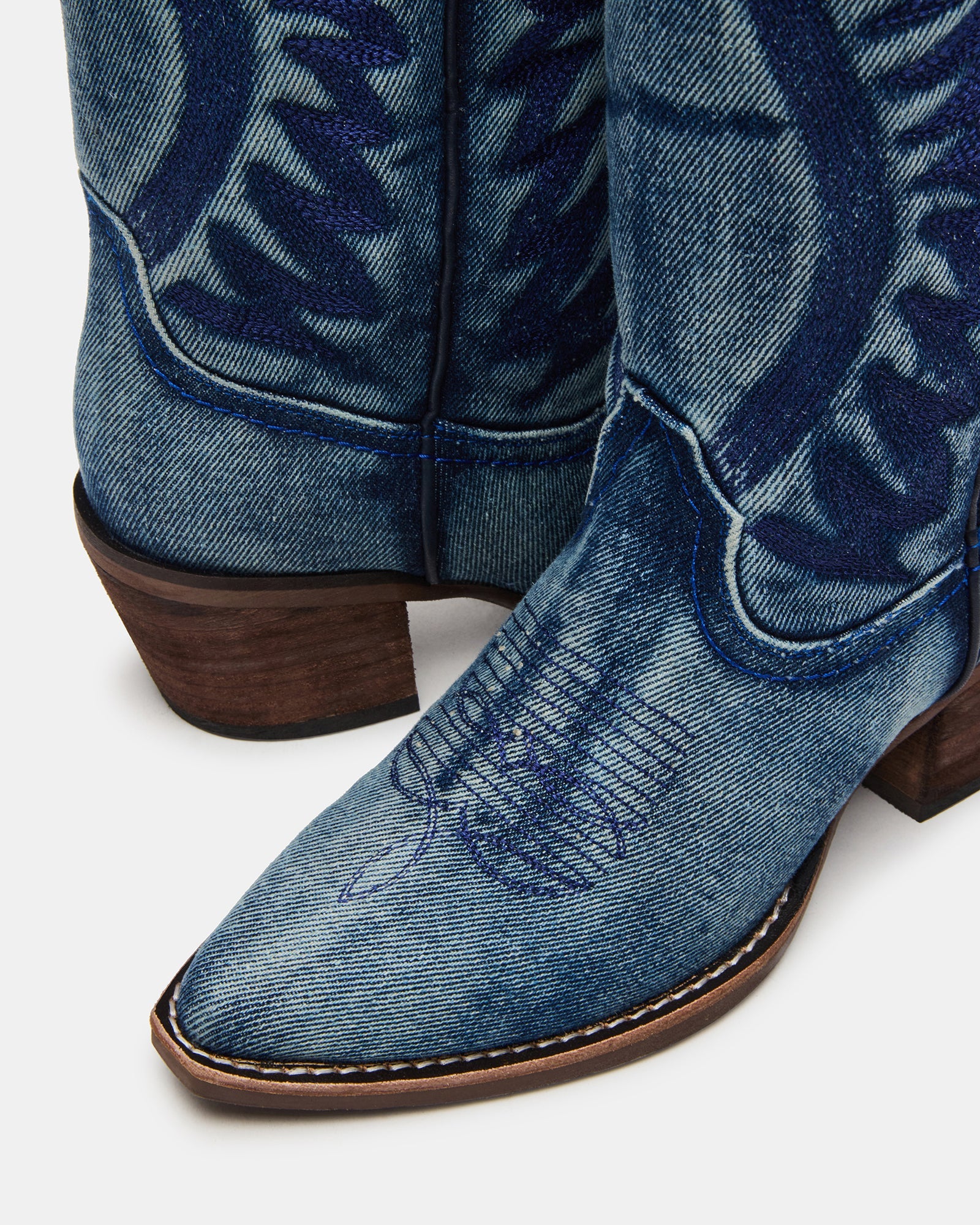 Steve Madden Albany denim fabric western boots with pointed toes and western-inspired design, featuring detailed stitching and a stacked heel.