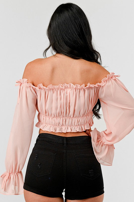 Off shoulder ruffle trim knot sleeve crop top by Bella Moda Latina, with fluttering ruffles and tied front detail.