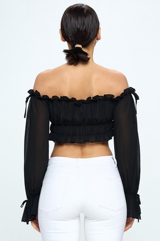 Off shoulder ruffle trim knot sleeve crop top by Bella Moda Latina featuring feminine ruffles and a stylish knot design.