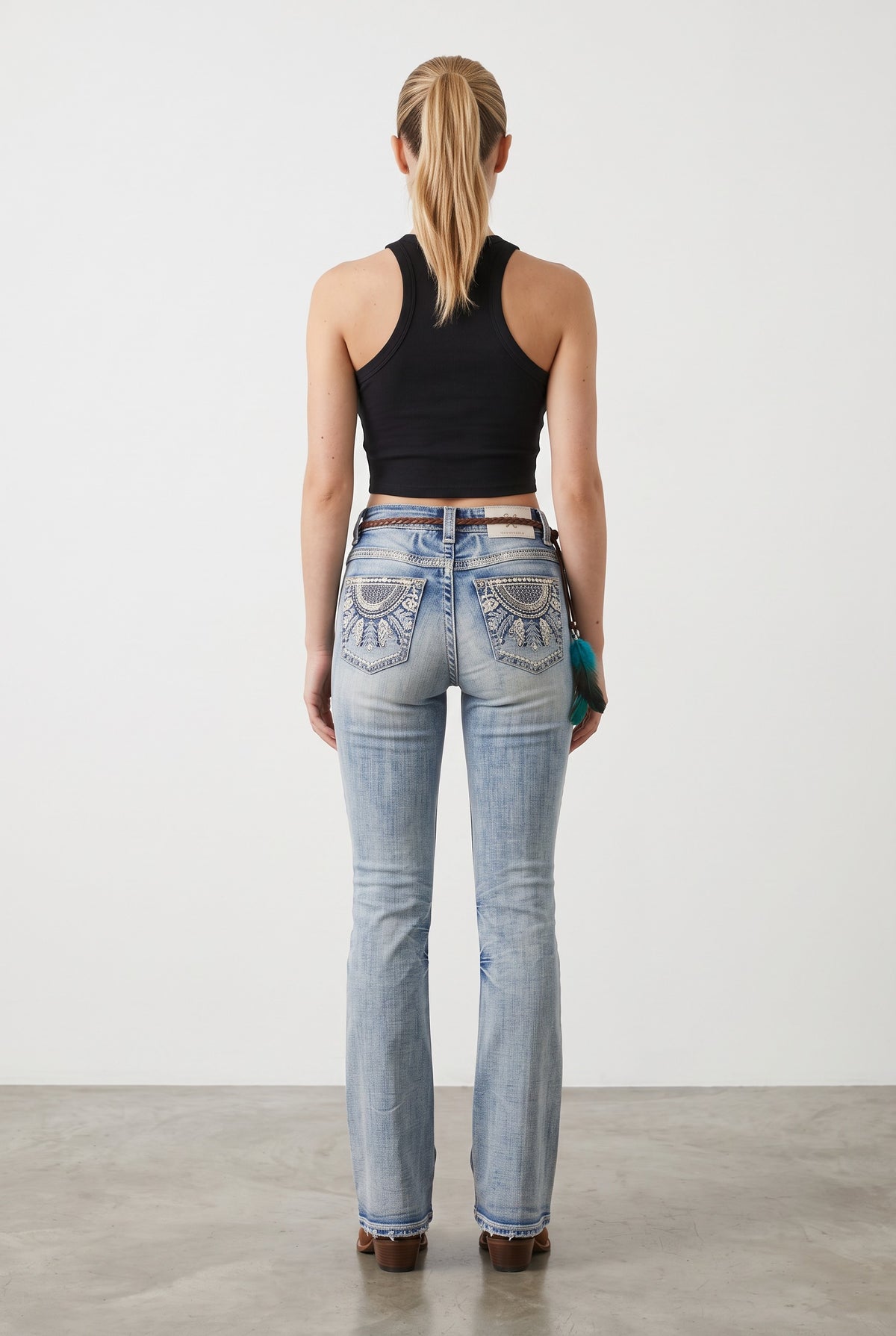 Back view of Western Blue W263 light wash bootcut jeans with fan-medallion embroidered back pockets and leather patch