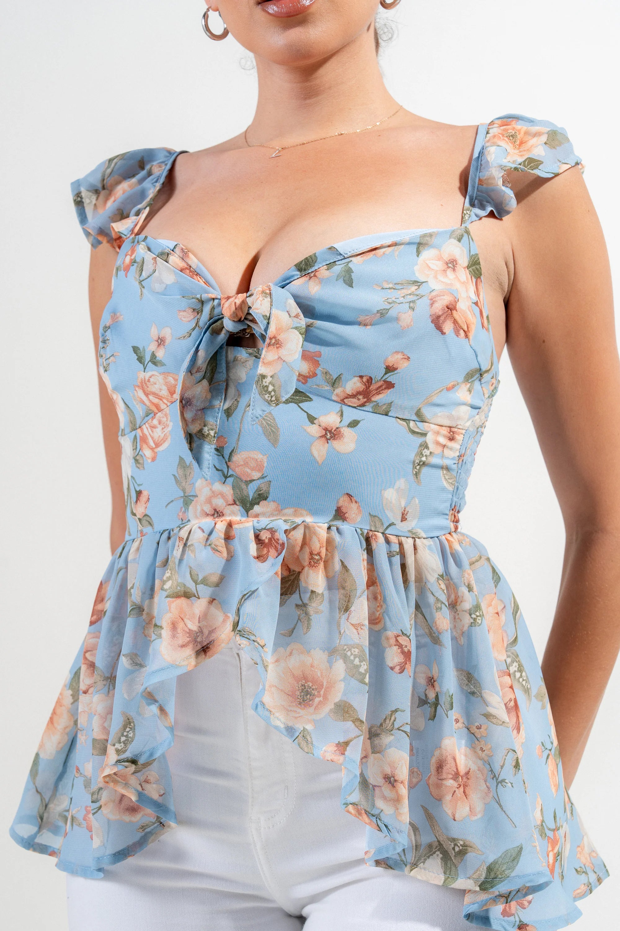 Blue multi floral knot tie sweetheart flutter ruffled top by Privy, featuring a feminine design with ruffles and a flattering fit.
