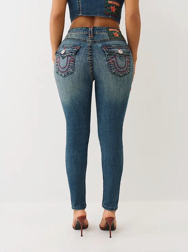 True Religion Jennie Super T mid-rise curvy skinny jeans displayed on a model, showcasing a fitted denim style with classic stitching.