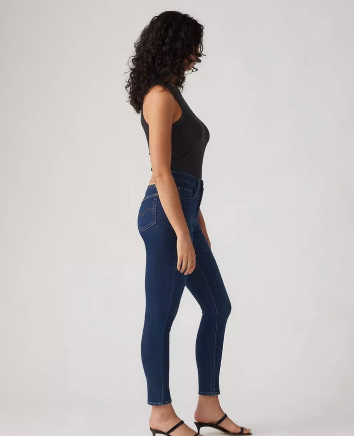 Levi’s 721 high rise skinny jeans in classic denim, styled on a model showcasing the fitted silhouette and high waist.