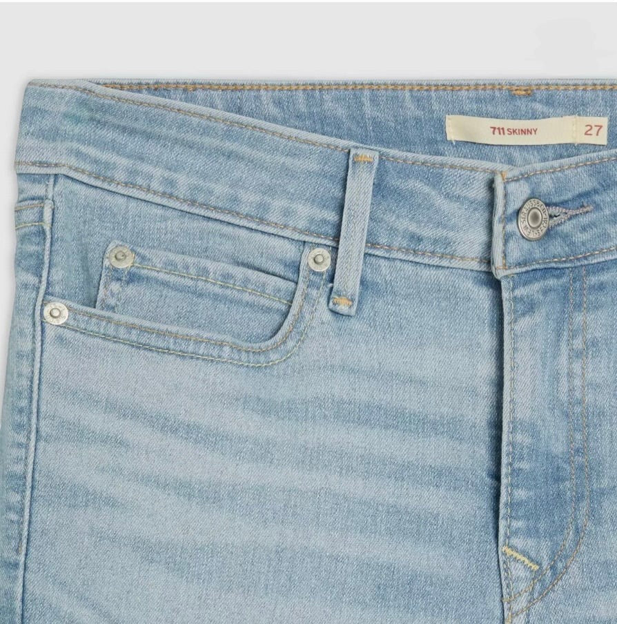 Vella Moda Levi's 711 light wash skinny jeans featuring a mid-rise waist, classic 5-pocket styling, and metal rivets.