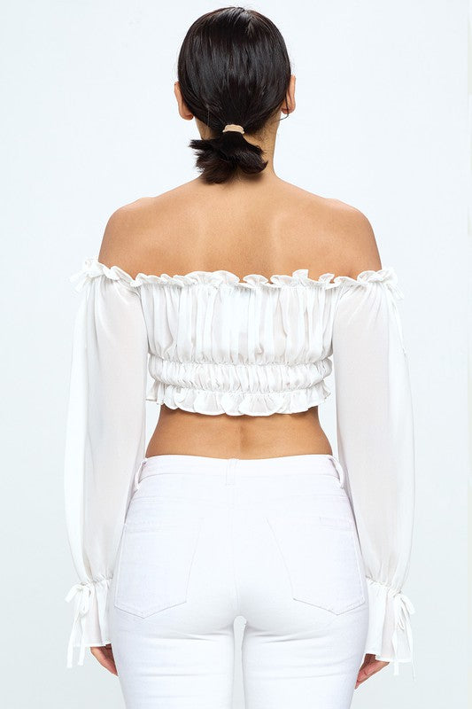 Off shoulder ruffle trim knot sleeve crop top by Bella Moda Latina, featuring flowy ruffles and a stylish knot detail.