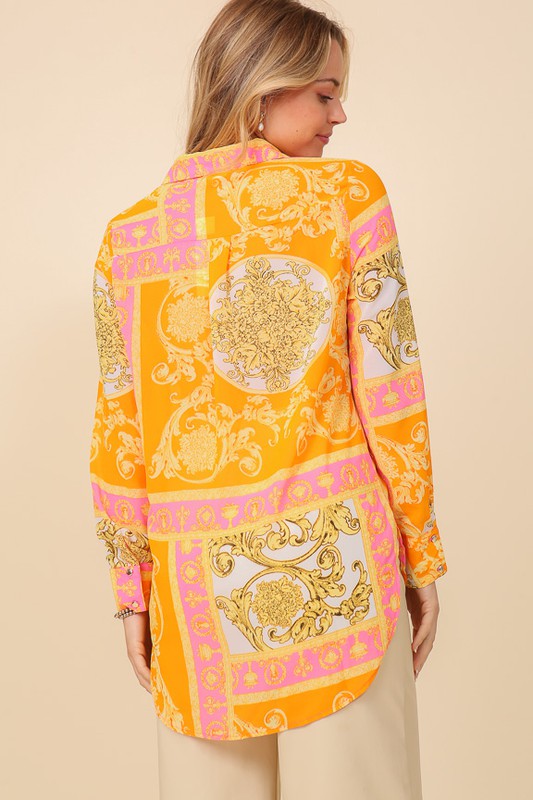 Bella Moda Latina Italian print button-down top with long sleeves and vibrant pattern, displayed on a hanger.
